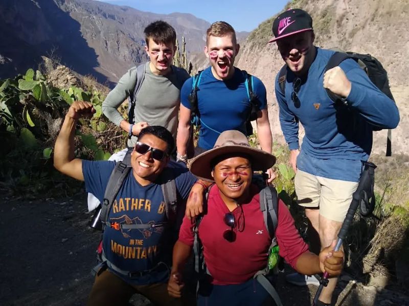 A happy group of trekkers and their guide posing on the 3 day Colca Canyon Trek Mountain Bike Tour.